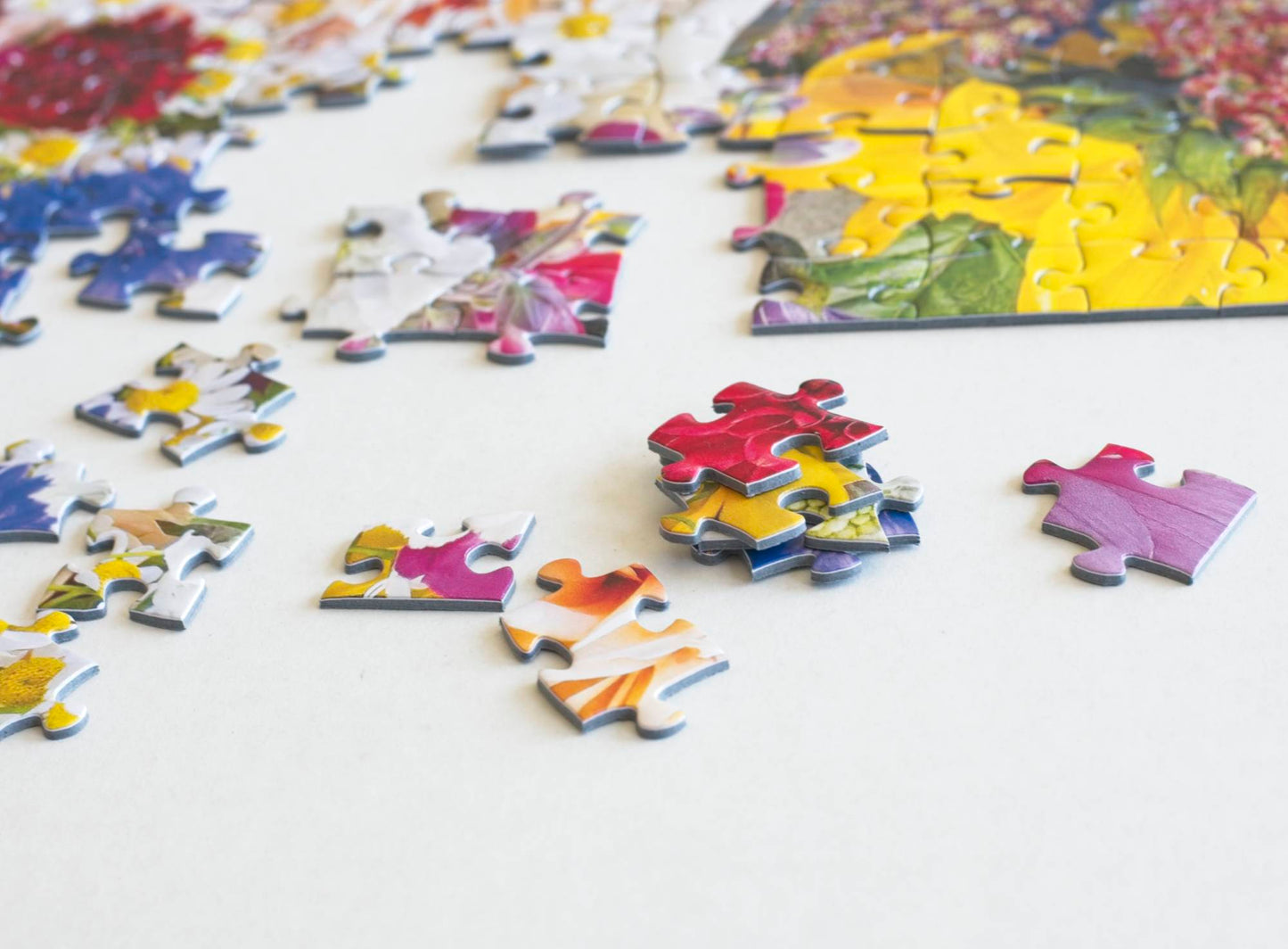 Colorful puzzle pieces on a white surface