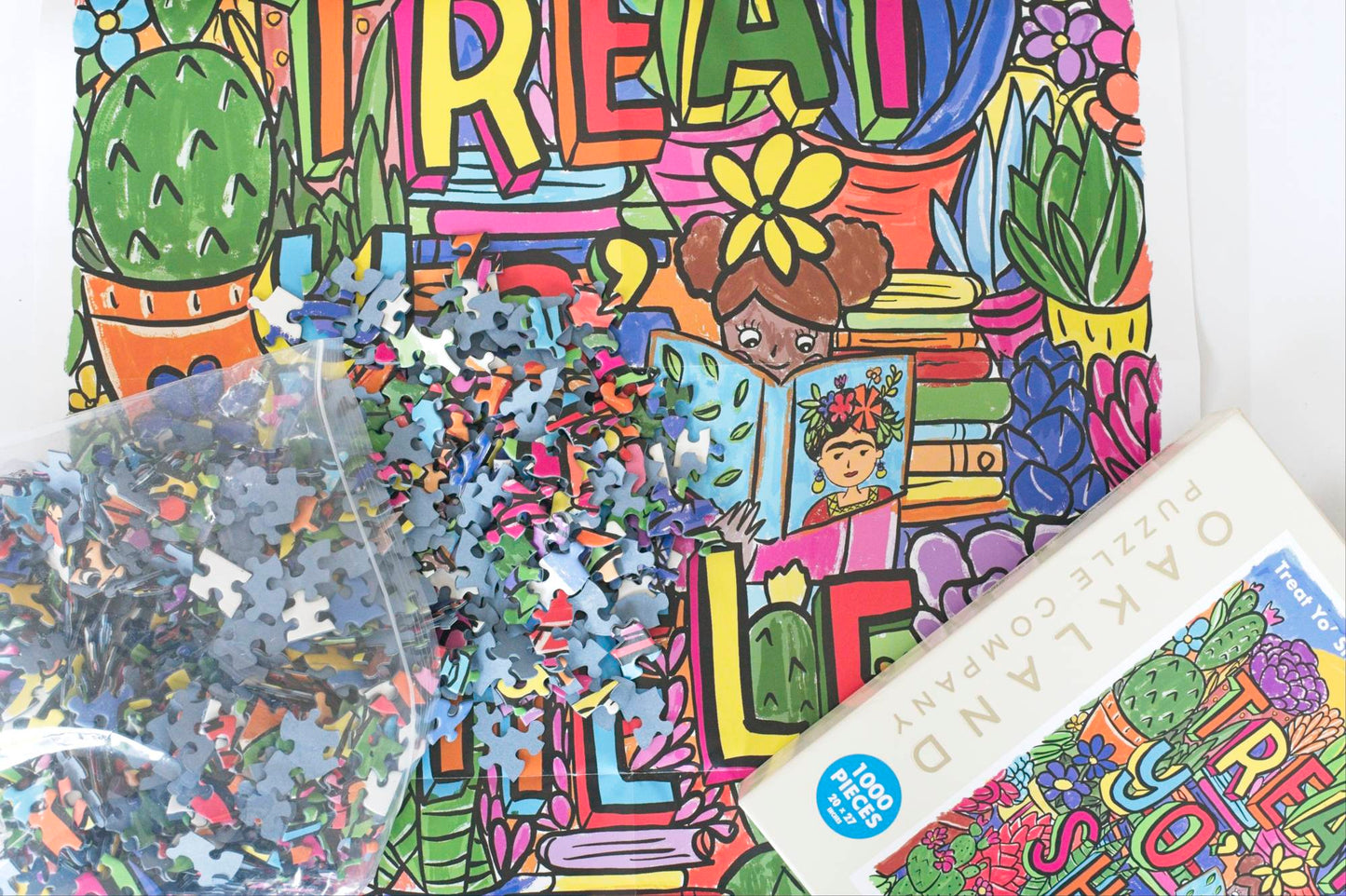 In the background is a large poster of the colorful puzzle image. Puzzle pieces spill out of a resealable plastic bag from the corner of a the photo toward the center of the poster and a puzzle box shows partially from the other corner.