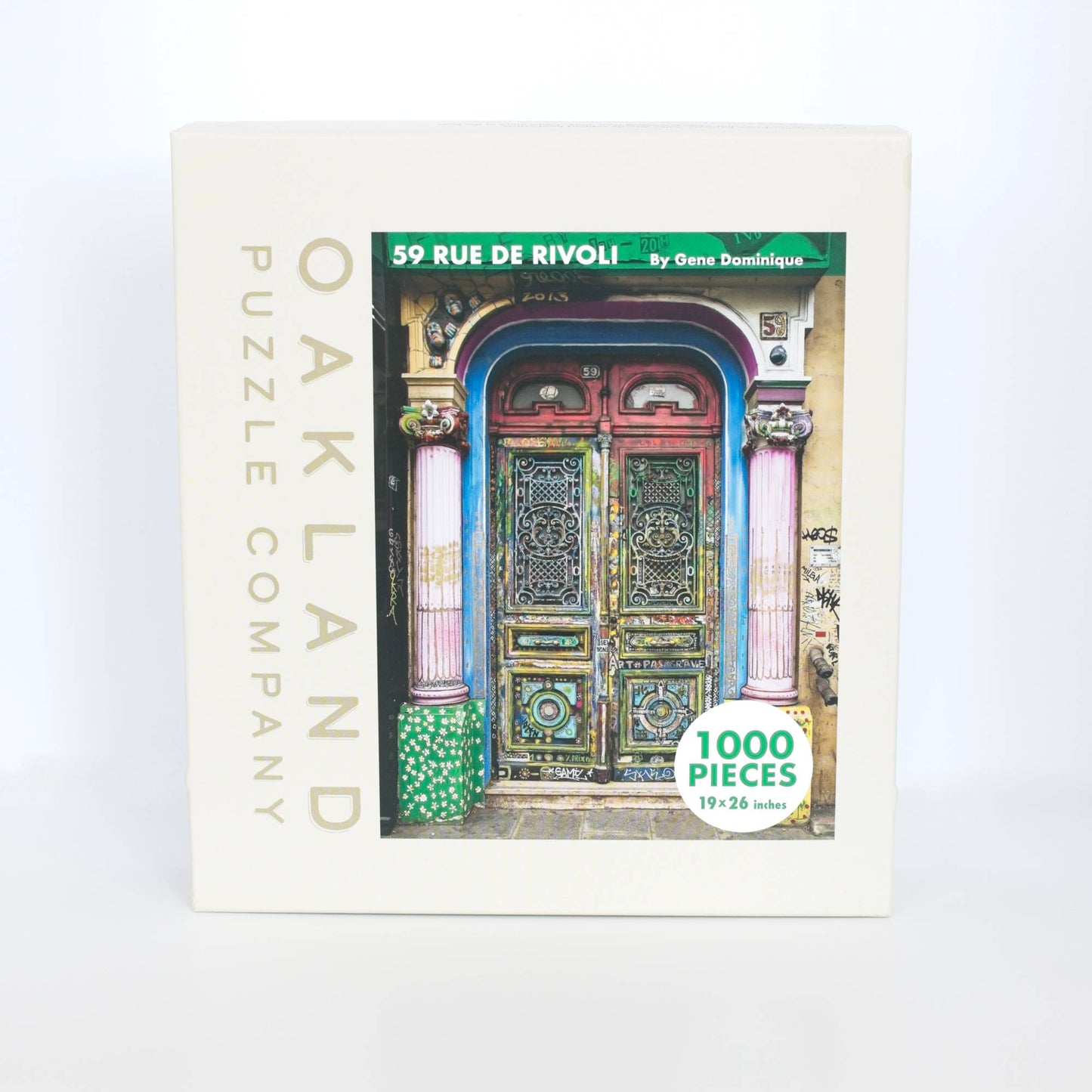 Jigsaw puzzle box with colorful door design and 'Oakland Puzzle Company' branding.