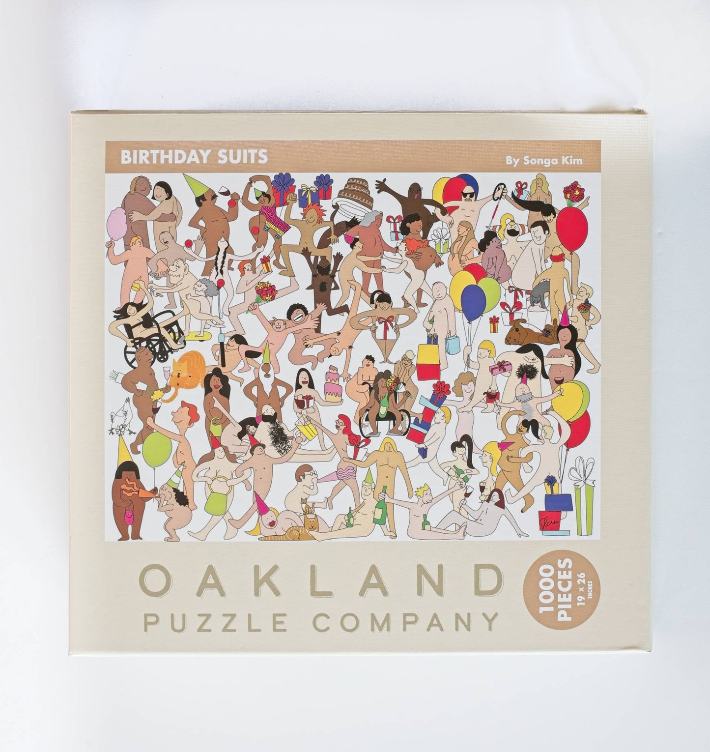 Oakland Puzzle Company puzzle box with illustrations of people in birthday suits on a white background