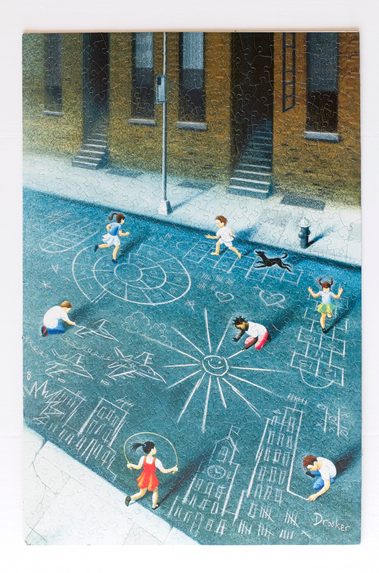 A complete jigsaw puzzle featuring an illustration of children playing on the street in front of New York brownstones.