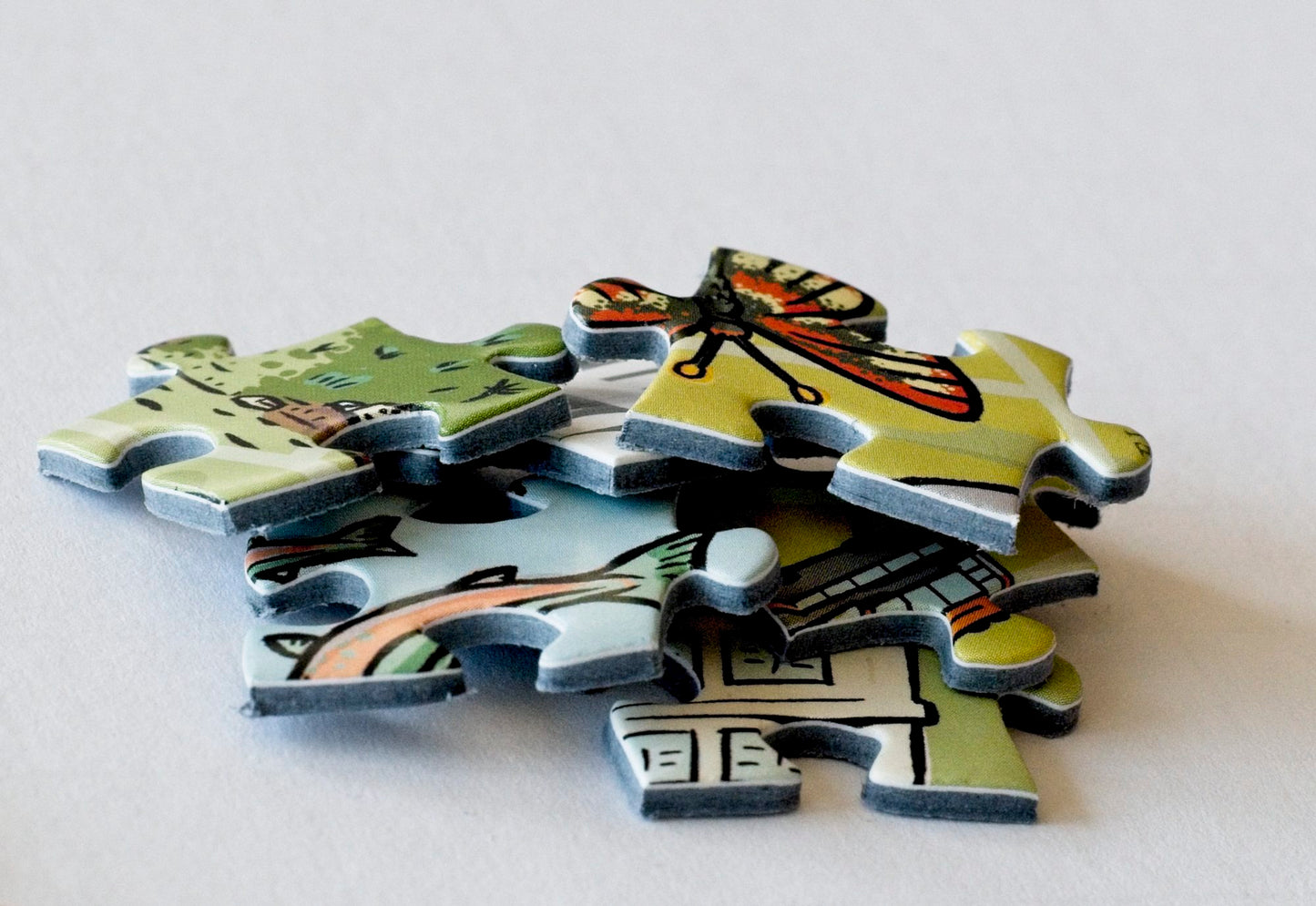 A close-up shot of colorfully illustrated puzzle pieces in a pile