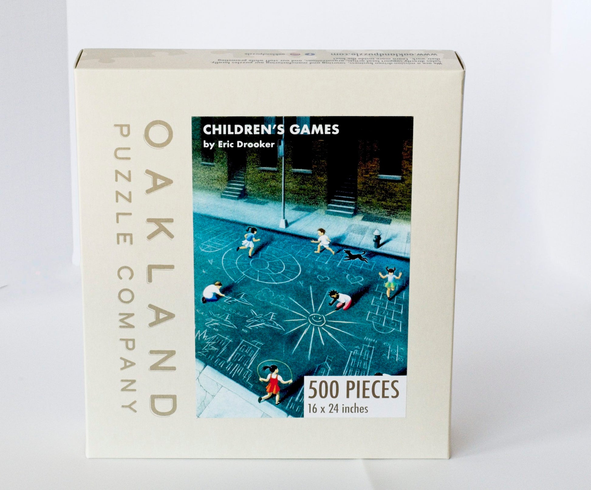 A box branded Oakland Puzzle Company featuring the Children's Games image on the front.