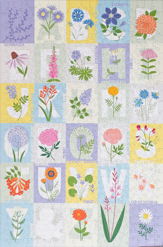 A completed puzzle showing grid of pastel colors with the letters a-z on most of the squares desgined with a flower corresponding to that letter.