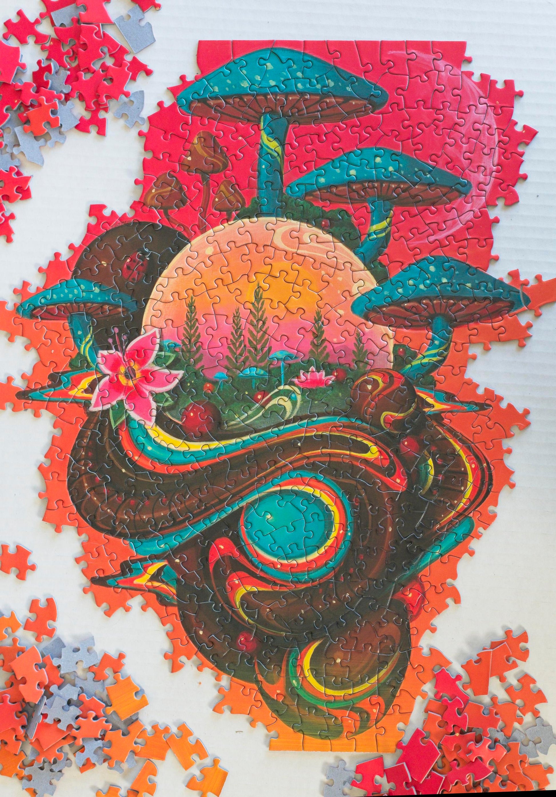 A partially completed puzzle with msuhrooms, flowers and orbs on a pink and orange gradient with a moon in the background.