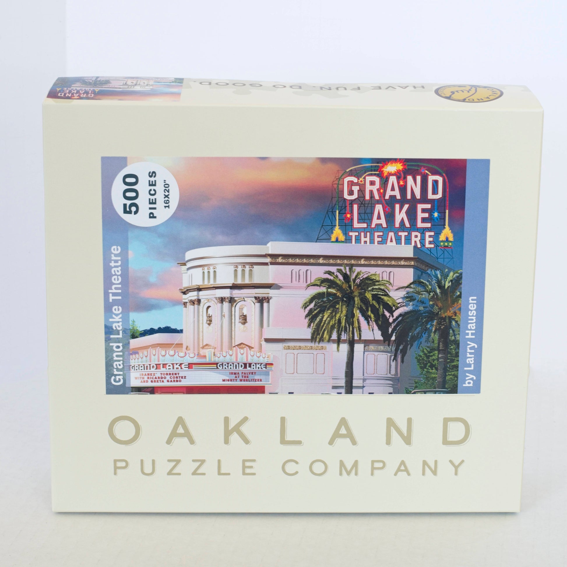 A box branded Oakland Puzzle Company with an image of a classic art deco theater with a lit sign that says Grand Lake Theatre under a striking cloudy sky