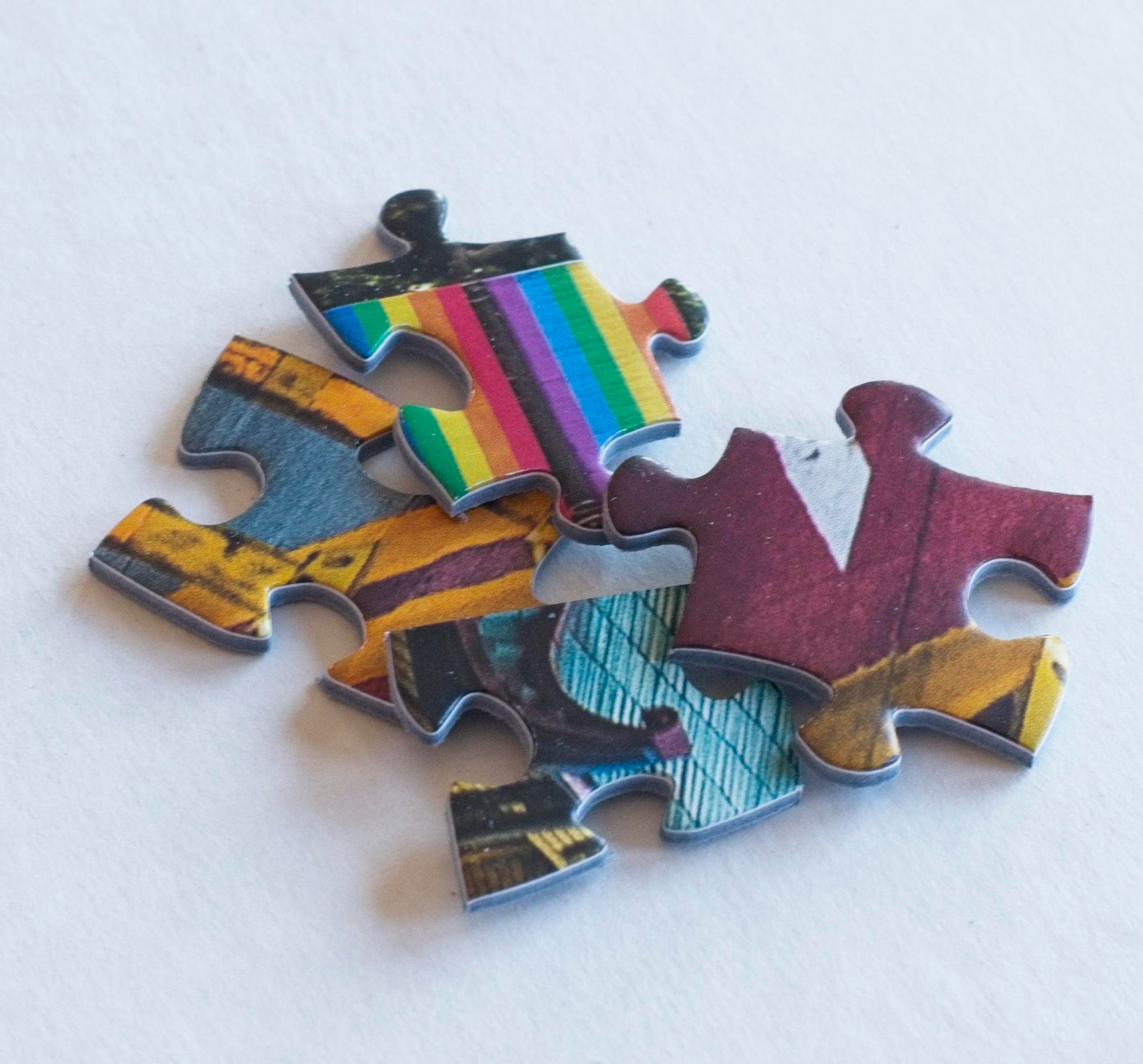 A close shot of 4 colorful puzzle pieces