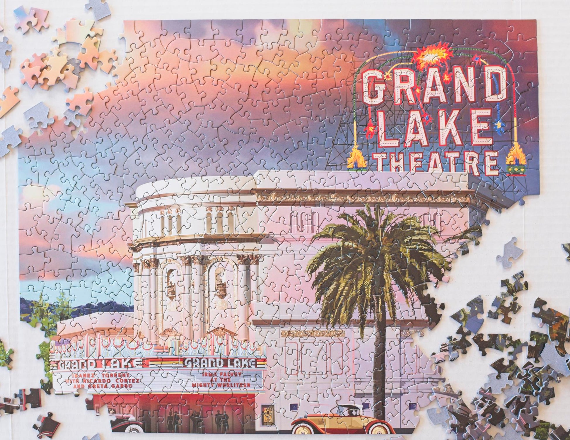 The Grand Lake Theatre puzzle nearly complete except for 3 corners with pieces strewn around.
