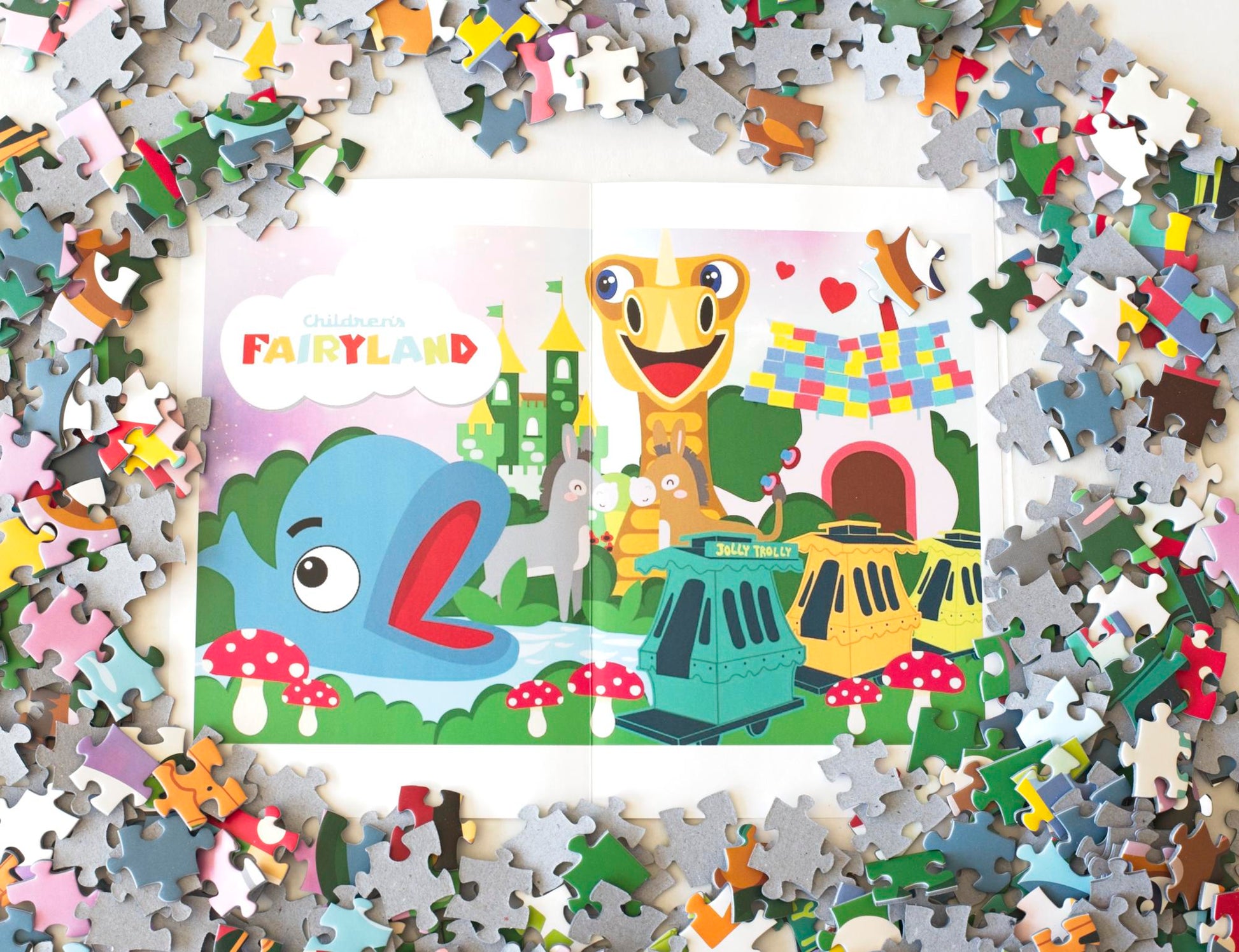 A colorful poster showing illustrated features of Children's Fairyland with a ring of puzzle pieces surrounding it.