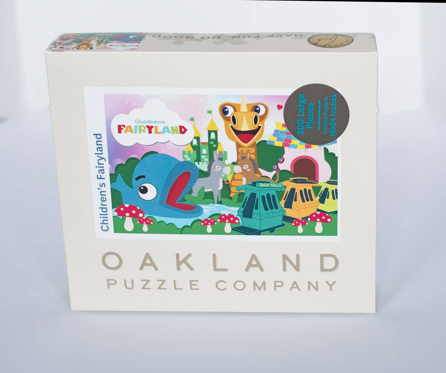 A photo of a box labeled Oakland Puzzle Company labeled with a cartoon-like illustration of a Children's Theme Park, Children's Fairyland. Marked 300 Large PIeces Finished Puzzle is 16x24 Inches