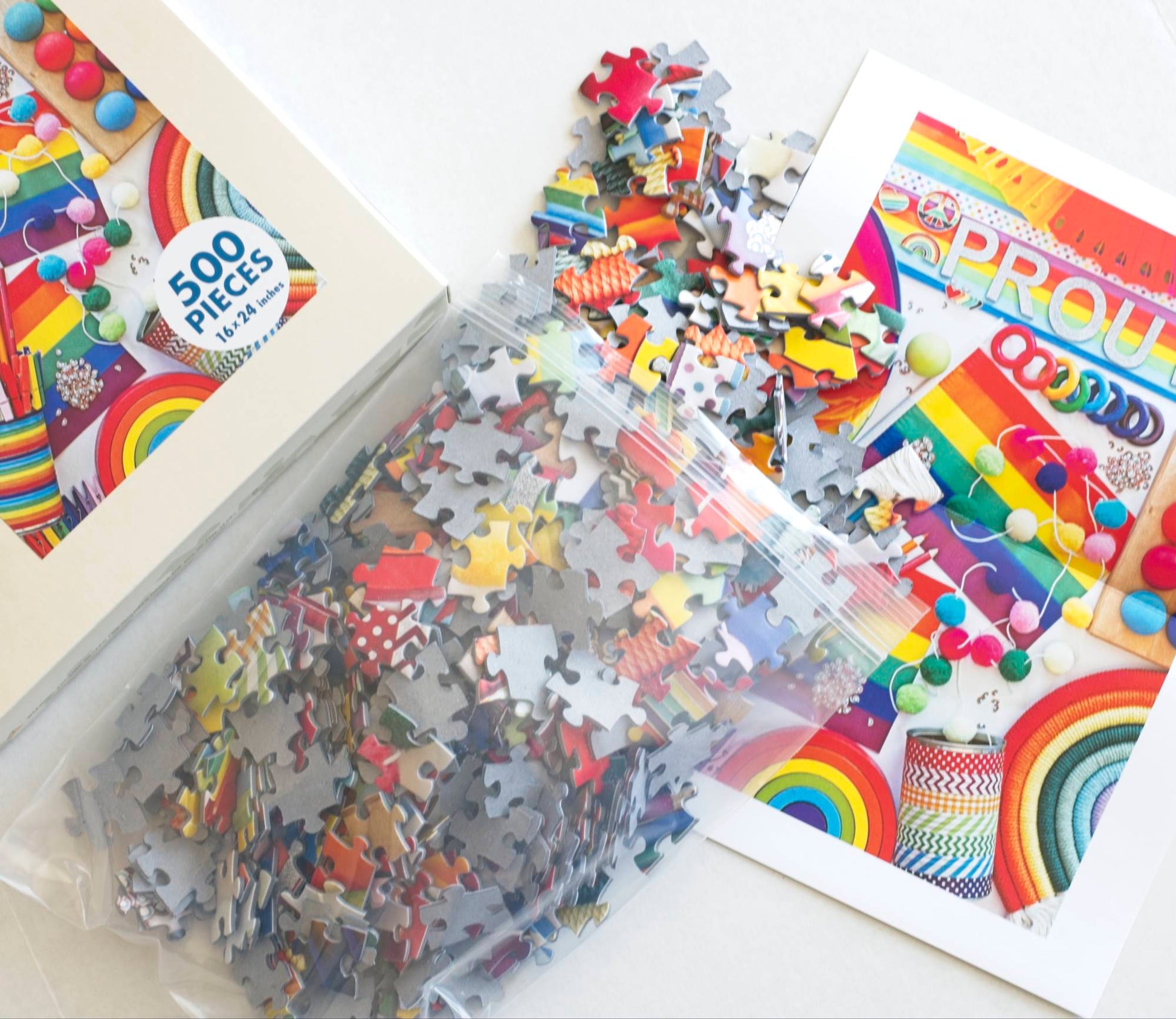 Jigsaw puzzle with colorful pieces and packaging on a white surface