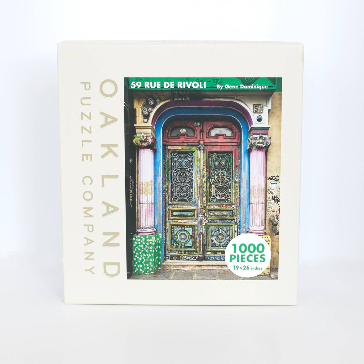 Jigsaw puzzle box with colorful door design and 'Oakland Puzzle Company' branding.