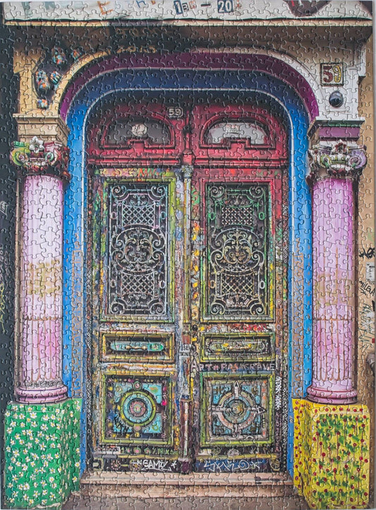 Decorative door of 59 Rue de Rivoli, a legalized Paris artist squat, with intricate patterns and colorful columns