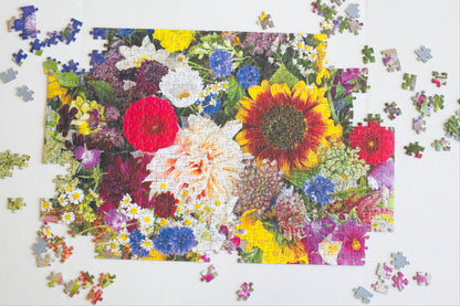 A partially completed jigsaw puzzle with a colorful floral design on a white background