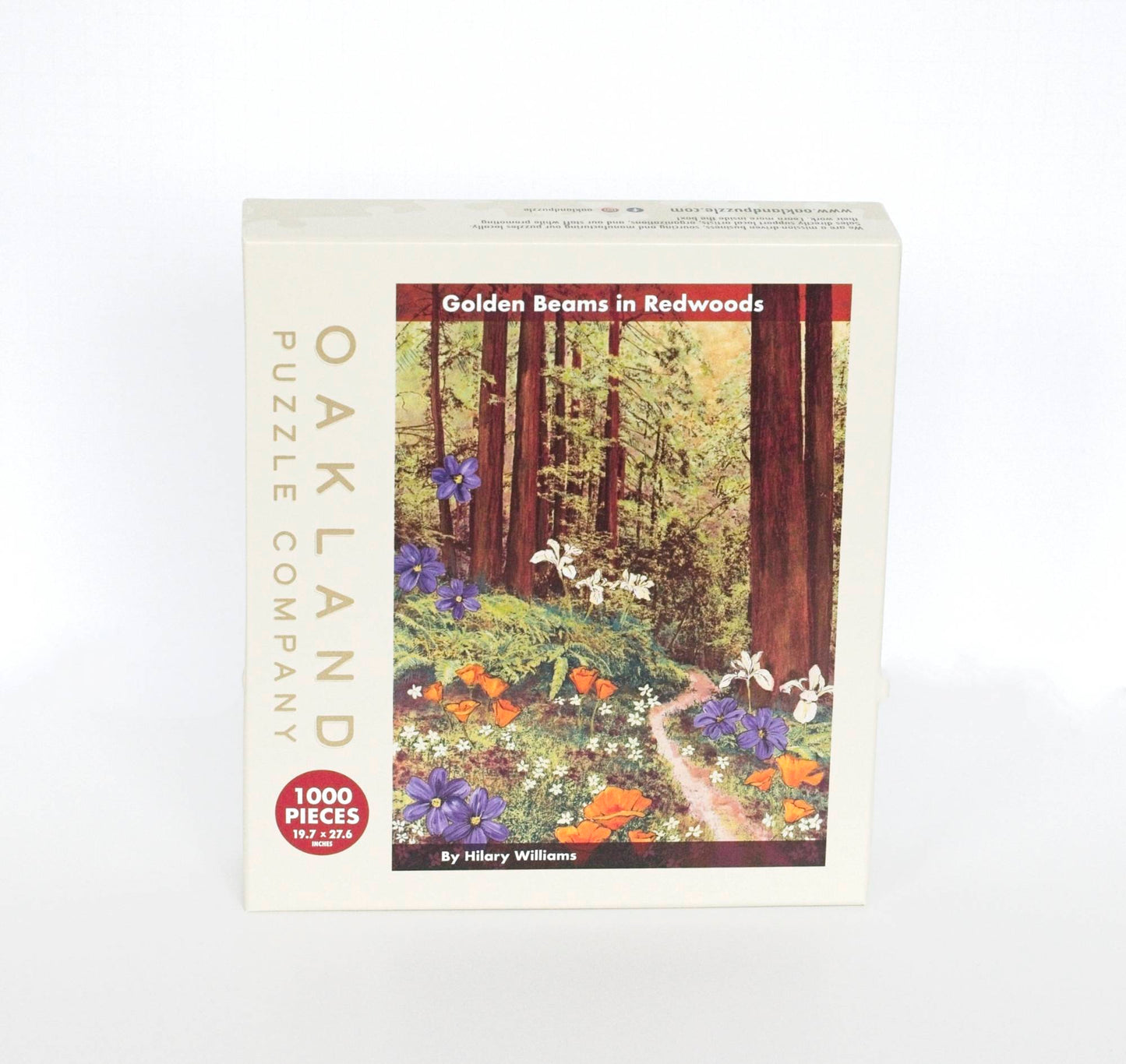 A beige product box branded Oakland Puzzle Company with the text Golden Beams in Redwoods By Hilary Williams 1000 Pieces 19.7x27.6 inches