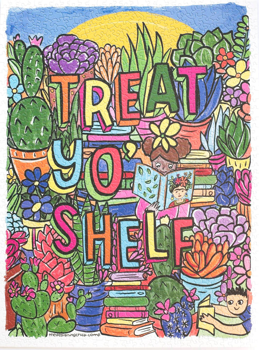 A photo of a completed random-cut puzzle featuring a drawn image filled with colorful succulents and flowers and stacks of books. The words Treat Yo' Shelf are written in multi-colored block letters with shadows. In the center a child wearing pink reads a book with Frida Kahlo on he cover and another child wearing blue reads near the corner.  At the top appears to be a blue sky and giant sun.