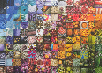 A photo of a completed traditionally cut jigsaw puzzle featuring a collage of 140 photos in a grid arranged roughly in a rainbow showing fruits, vegetables, flowers, textiles, and other goods commonly found in grocery stores.