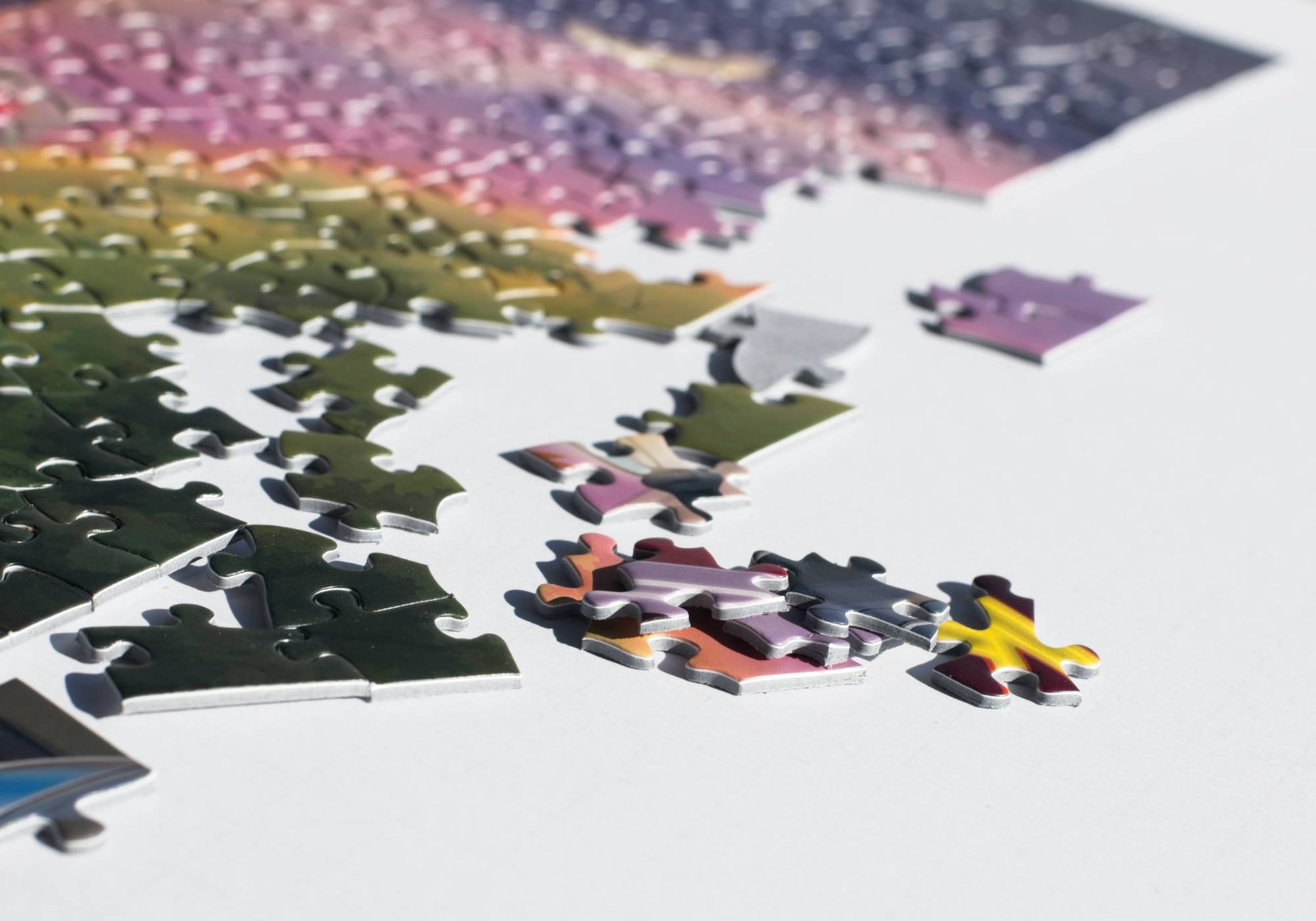 Partial puzzle with colorful pieces on a white surface