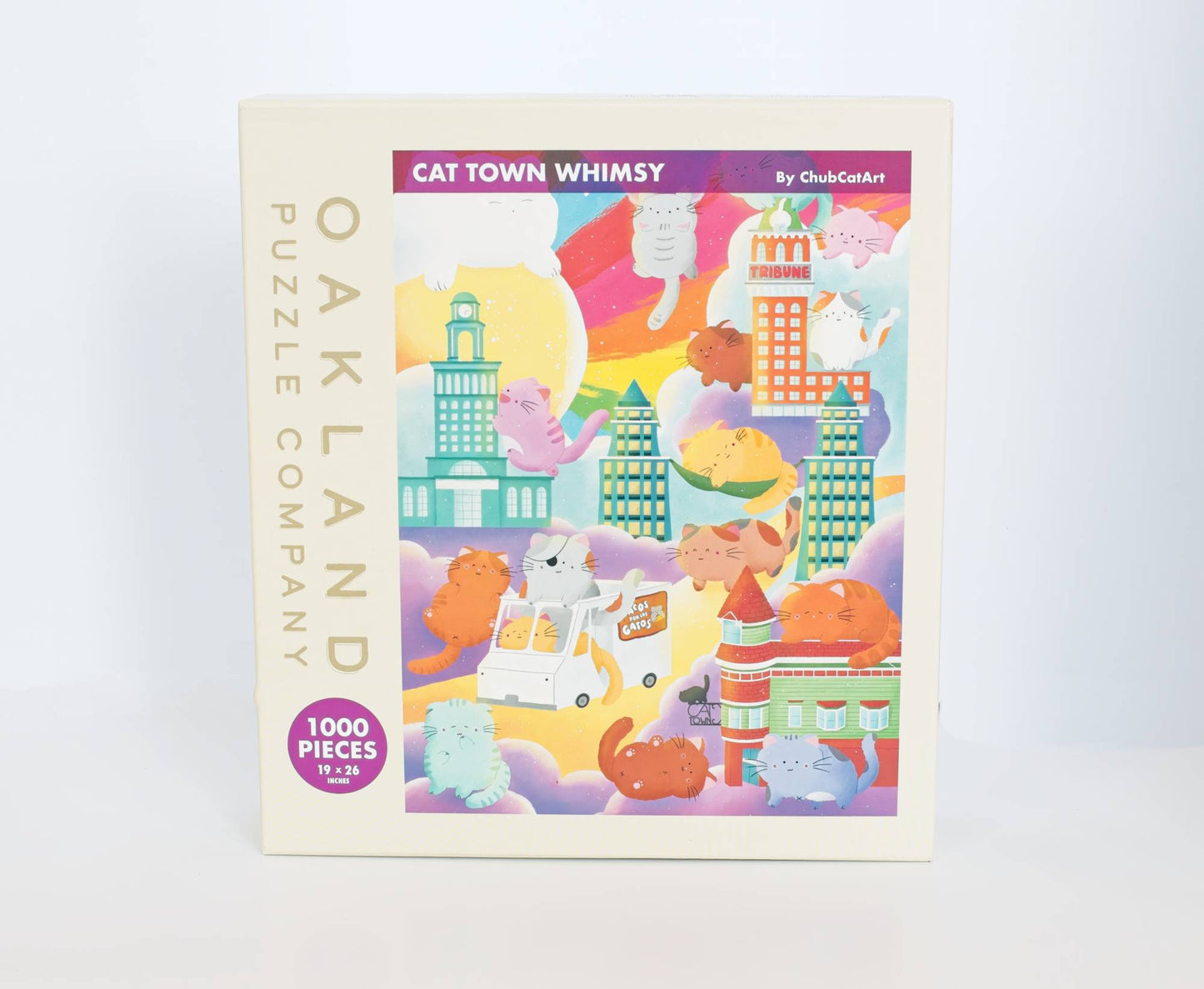 Puzzle box with colorful illustration of cartoon characters and buildings, labeled 'Cat Town Whimsy' by Oakland Puzzle Company.