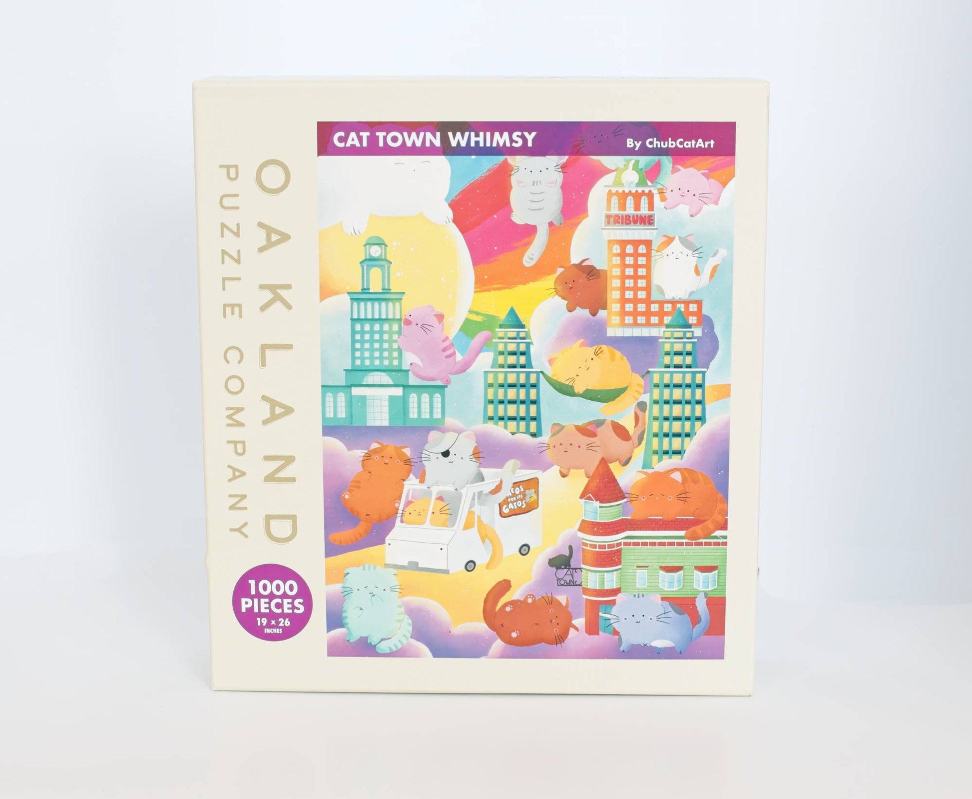 Puzzle box with colorful illustration of cartoon characters and buildings, labeled 'Cat Town Whimsy' by Oakland Puzzle Company.