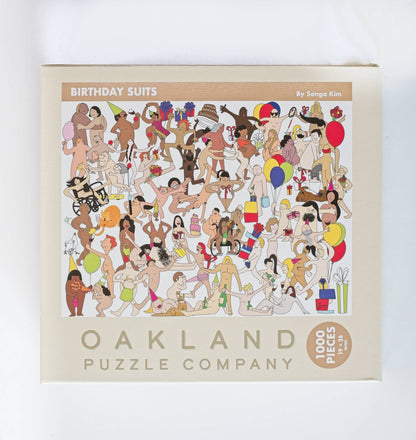 Oakland Puzzle Company puzzle box with illustrations of people in birthday suits on a white background