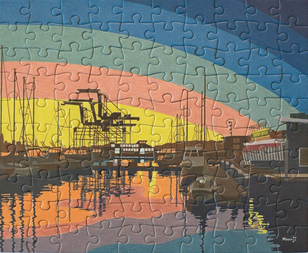 A completed jigsaw puzzle showing a stylized harbor scene with boats, cranes, and colorful sunset-like bands in blue, teal, pink, yellow, orange, and dark gray.