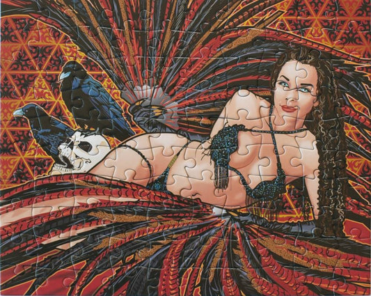 A completed jigsaw puzzle featuring a stylized illustration of a reclining woman with long dark hair, wearing a black fringed bra and matching skirt, posed with two black crows and a white skull against a red, orange, and black patterned background.