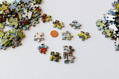 Colorful puzzle pieces scattered around a penny to show that the pieces are aslightly larger size.