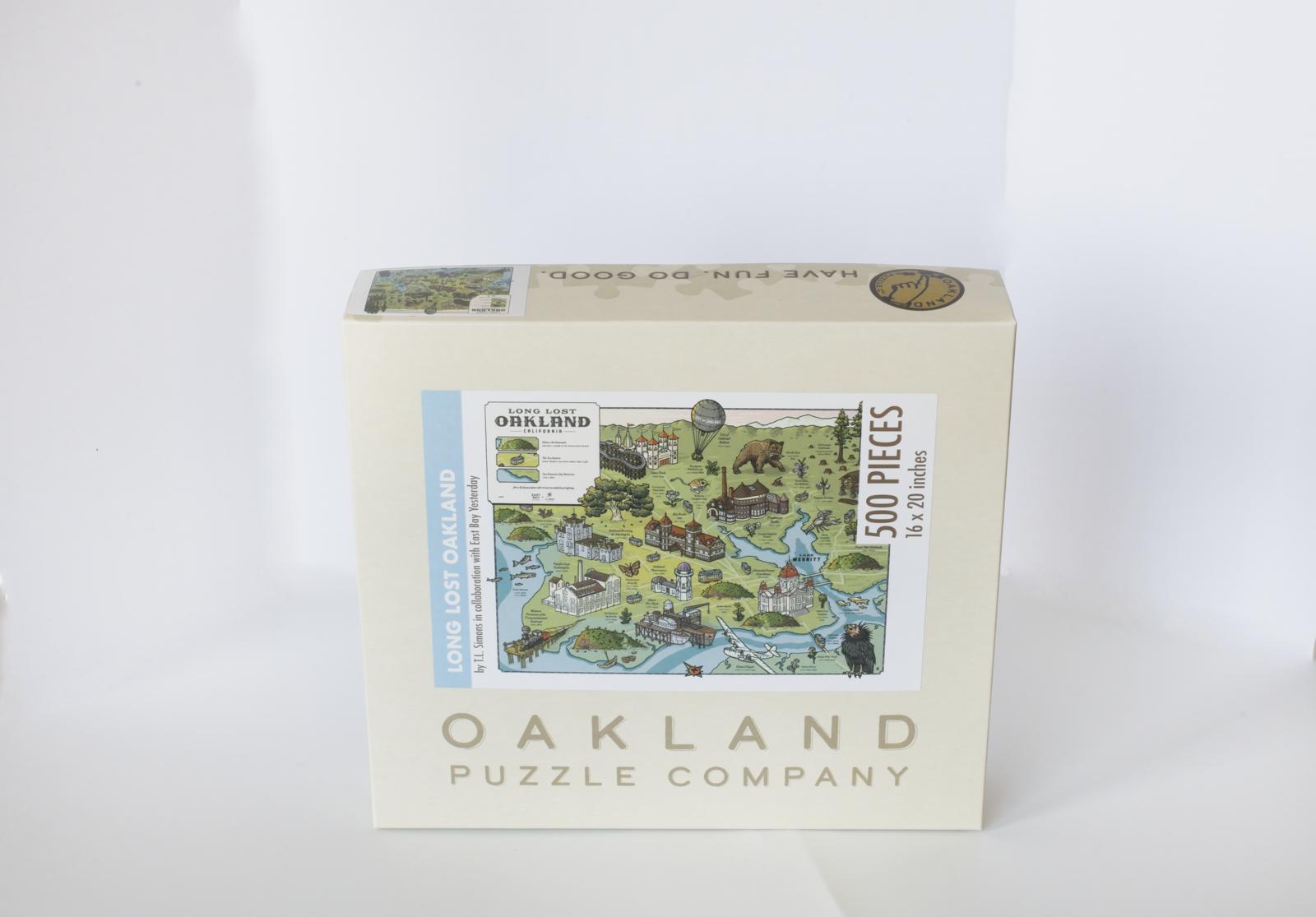 A box branded Oakland Puzzle Company with an image of a map featuring buildings and wildlife. Labeled Long Lost Oakland with East Bay Yesterday