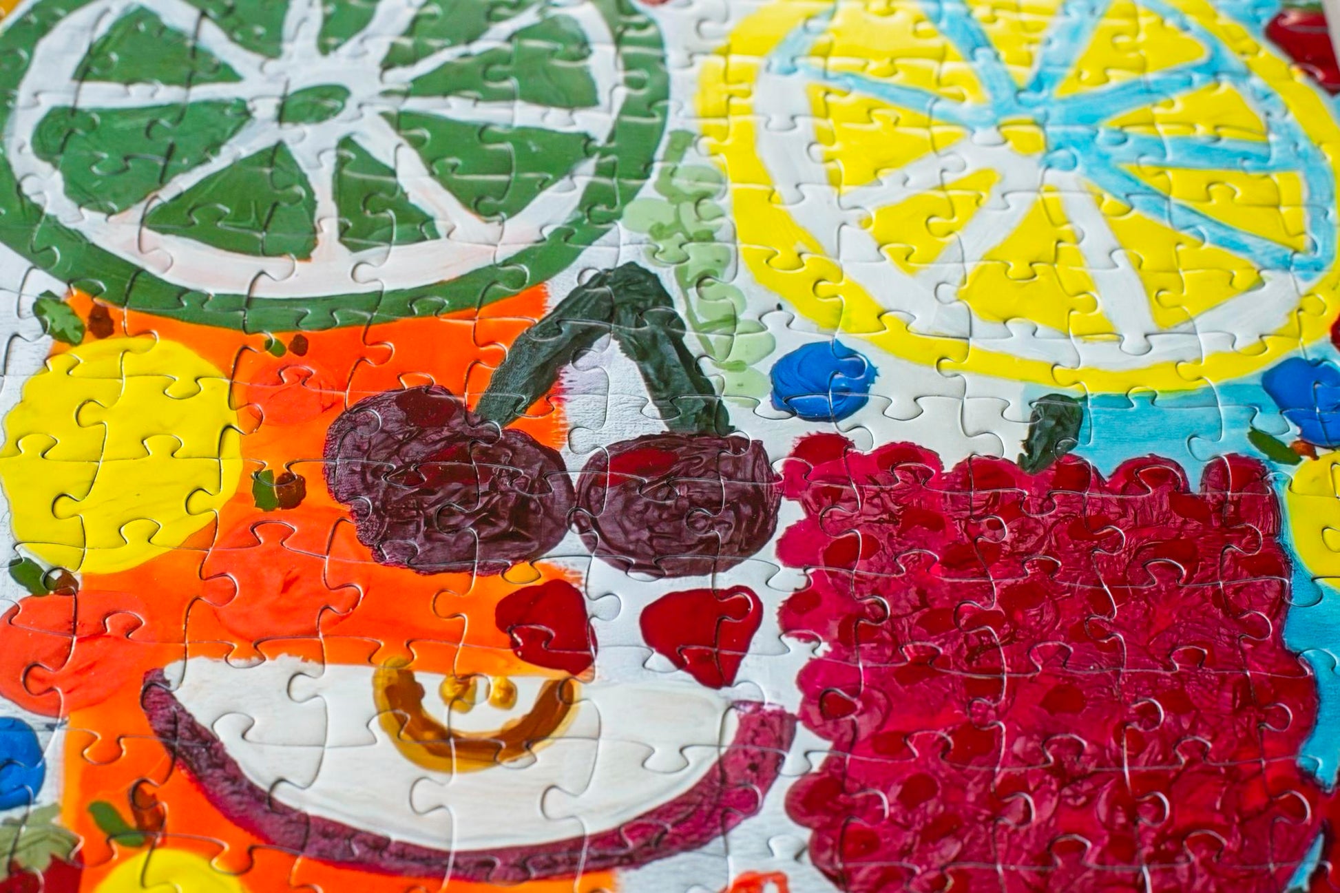 A variety of fruit pieces depicted in a section of a colorful jigsaw puzzle.
