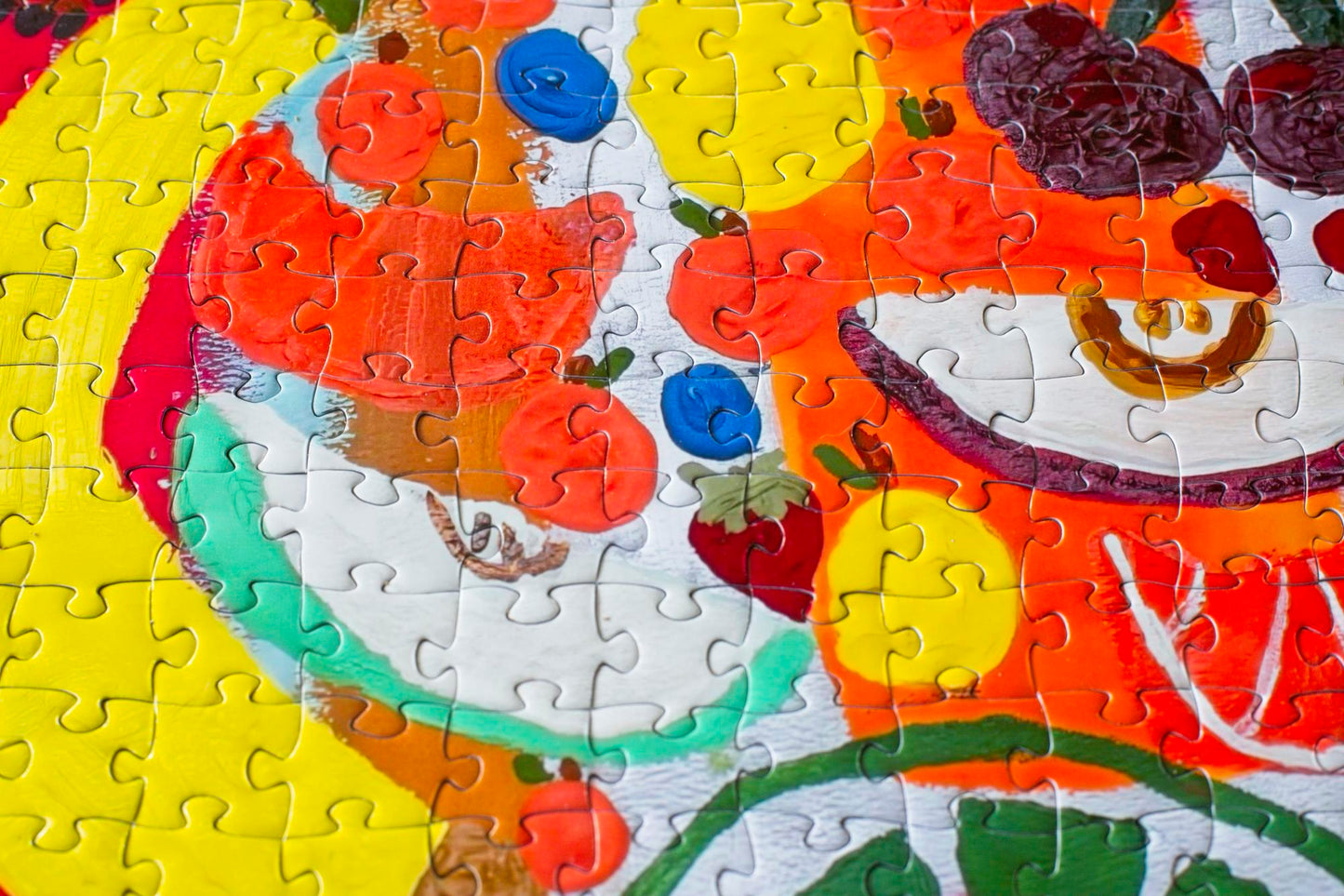 A variety of fruit pieces depicted in a section of a colorful jigsaw puzzle