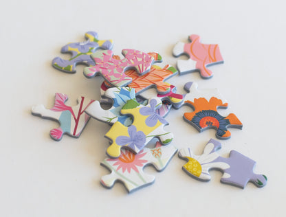 A close up photo of vibrant floral themed random-cut puzzle pieces