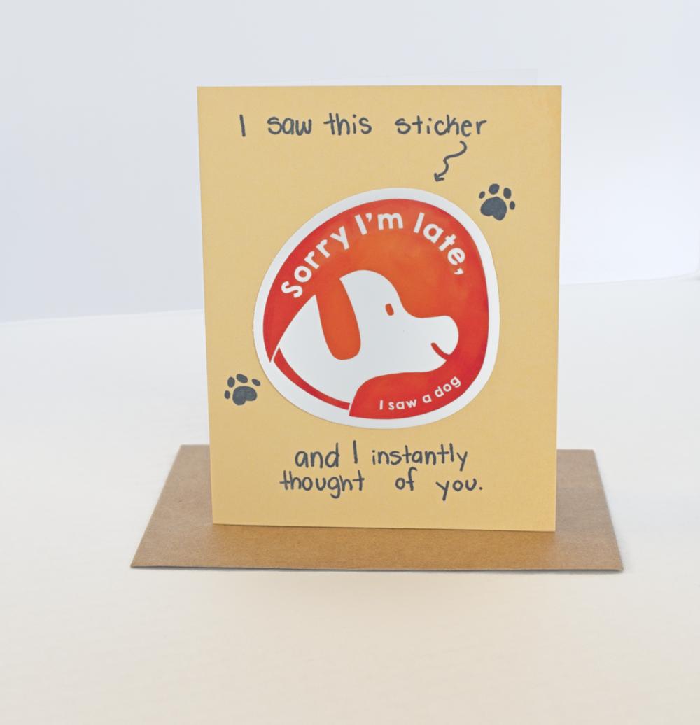 A yellow greeting card with the text I saw this sticker and I instantly thought of you and a sticker that says "Sorry I'm Late, I saw a dog"