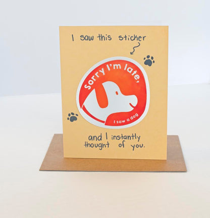 A yellow greeting card with the text I saw this sticker and I instantly thought of you and a sticker that says "Sorry I'm Late, I saw a dog"