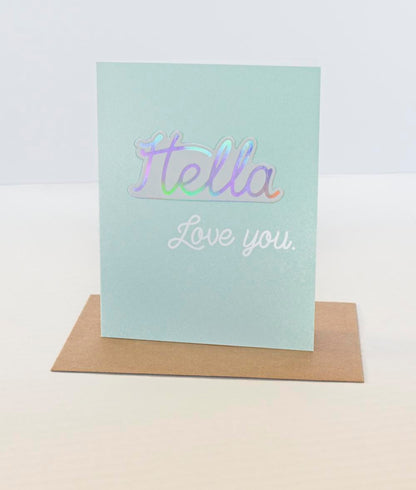 A sticker card with the name 'Stella' written on it, placed on a brown envelope, with a white background.