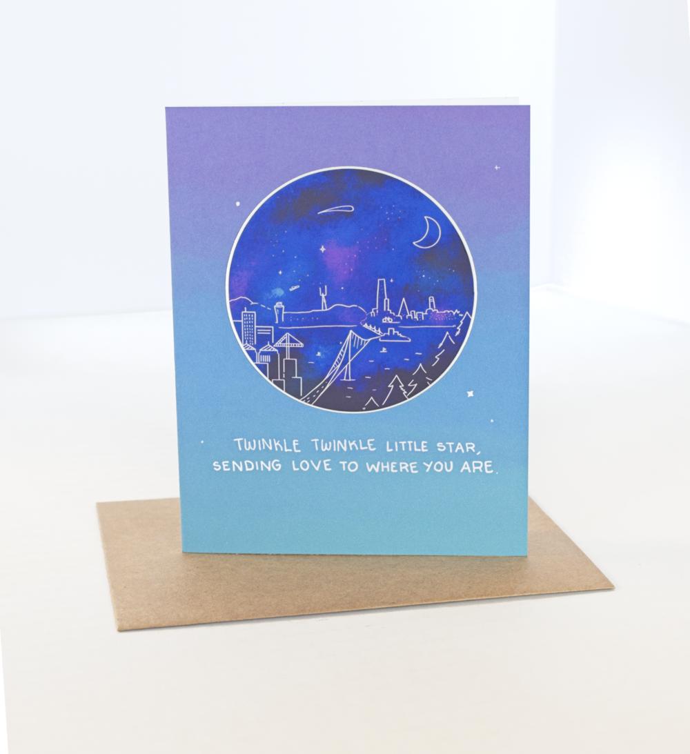 Blue greeting Card with a dark blue sticker with a whimsical doodle of a an evening scene of the Bay Bridge Leading to San Francisco with the text Twinkle Twinkle Little Star, Sending love to where you are.