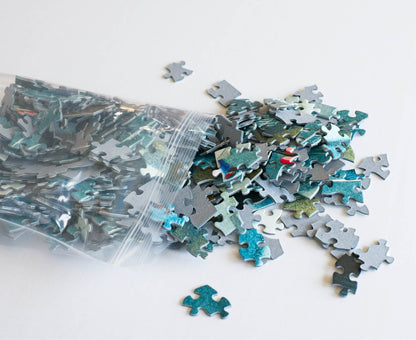 A resealable plastic bag spilling out puzzle pieces