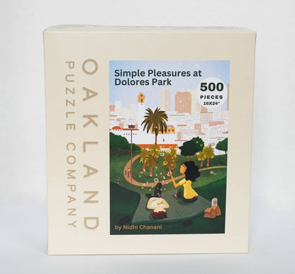 Oakland Puzzle Company box for the Dolores Park puzzle, showing bubble-blowing park scene illustration