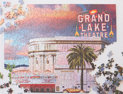 The Grand Lake Theatre puzzle nearly complete except for 3 corners with pieces strewn around.