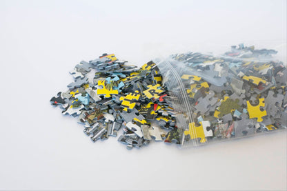 Colorful jigsaw puzzle pieces spilling out of a resealable plastic bag