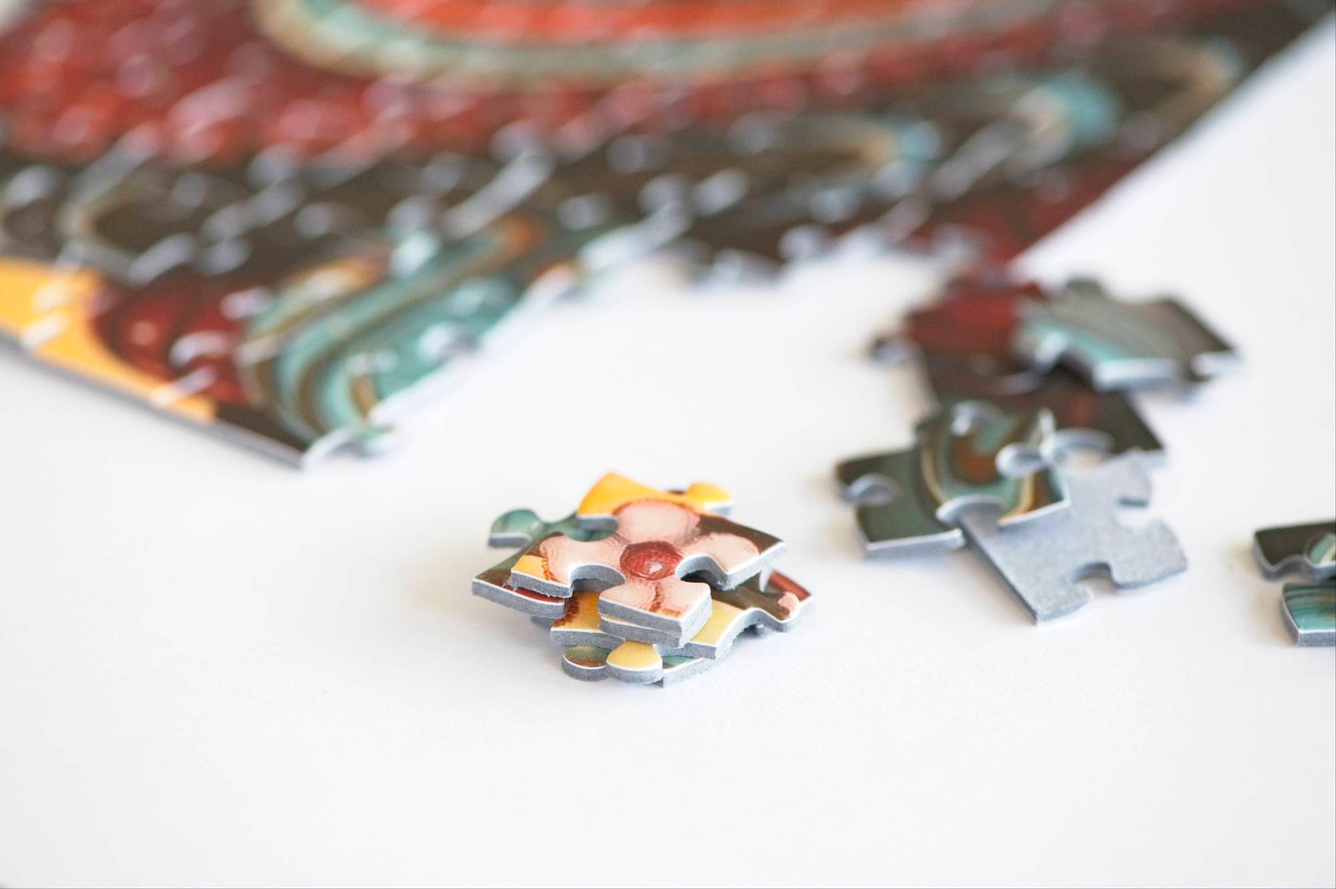 close up detail of colorful puzzle pieces made on blue board with a white background