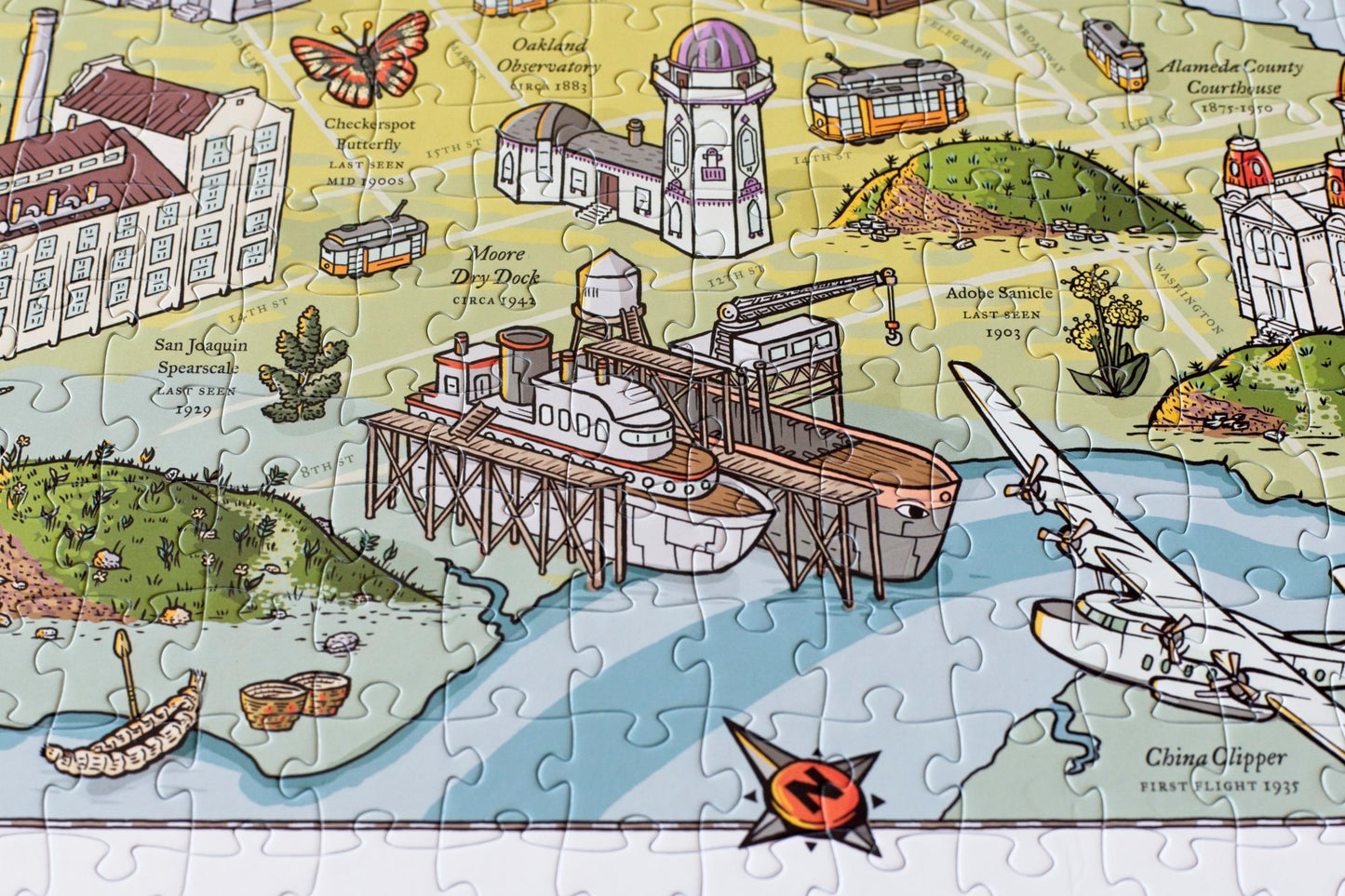 A close up of detail of a completed Long Lost Oakland puzzle featuring a dry dock and shellmound.