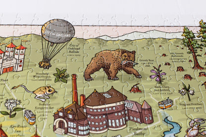 A close up of detail of a completed Long Lost Oakland puzzle featuring a Grizzly Bar and hot air balloon.