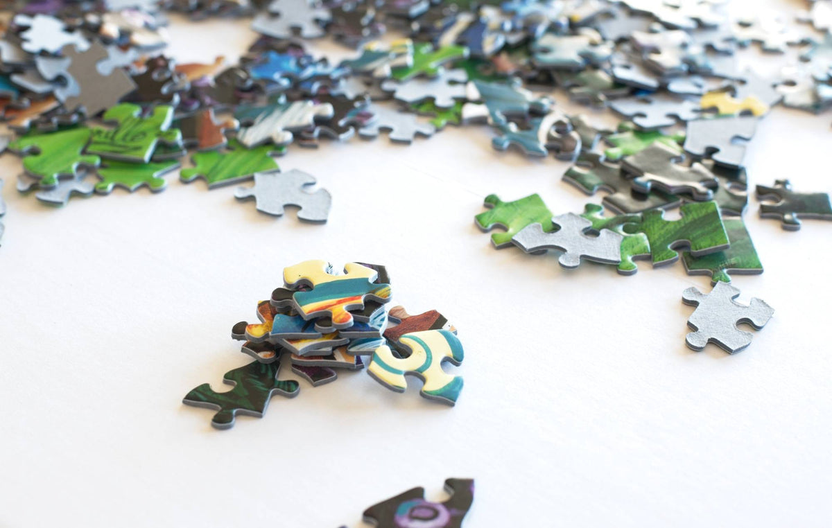 Scattered puzzle pieces on a white surface