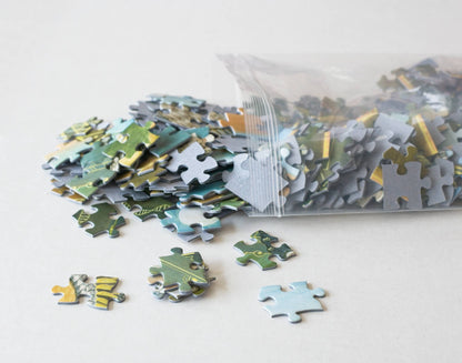Jigsaw puzzle pieces spilling from a clear resealable plastic bag on a white background