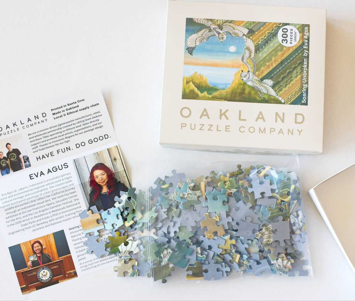 Oakland Puzzle Company puzzle set with packaging and leaflet on a white surface