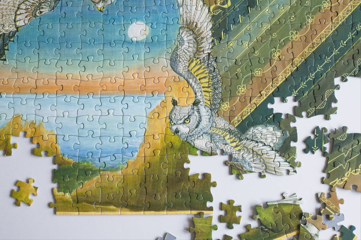 A partially completed colorful earth-toned jigsaw puzzle with an owl design on a white background.