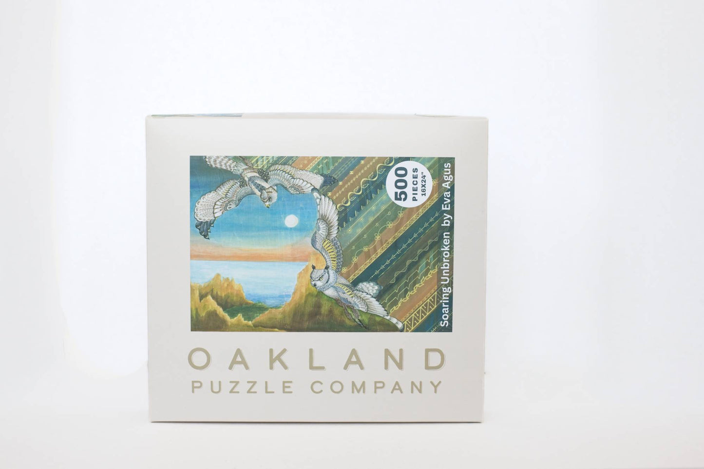 Oakland Puzzle Company puzzle box with artwork of birds and coastal landscape on a white background