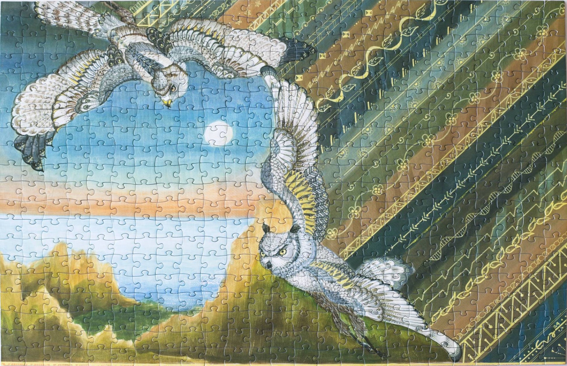 A photo of a completed jigsaw puzzle featuring two raptors and a rugged coastline with a batik pattern on one side.